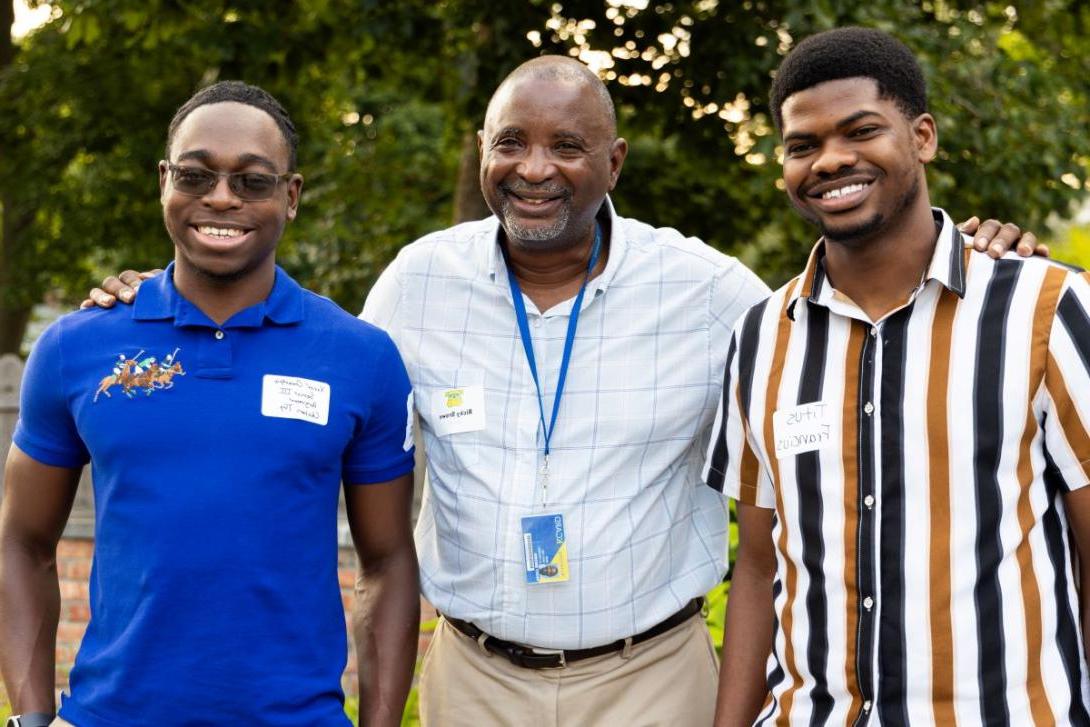 Ricky Brown, Kettering's director of multicultural student initiatives, smiles with students at Academically Interested Minds event